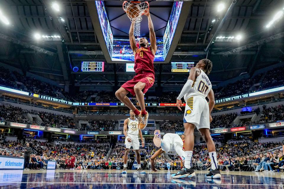 Cleveland Cavaliers forward Evan Mobley (4) dunks in front of Indiana Pacers guard Bennedict Mathurin (00) during the second half of an NBA basketball game in Indianapolis, Sunday, Feb. 5, 2023. (AP Photo/AJ Mast)