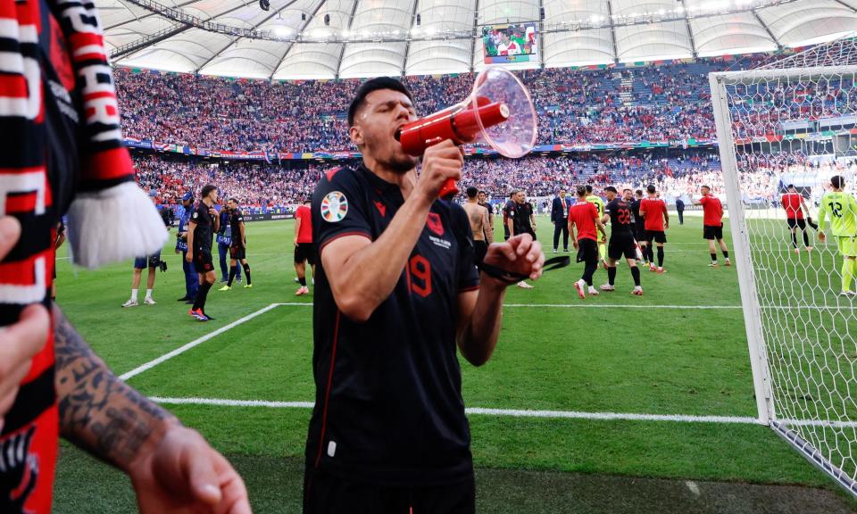 <span>Mirlind Daku used a megaphone to join supporters in nationalist chants.</span><span>Photograph: James Baylis/AMA/Getty Images</span>