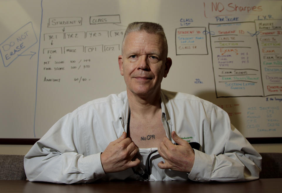 In this photo taken Sept. 29, 2011, Kansas City, Mo. pathologist Dr. Ed Friedlander displays his tattoo with a medical directive to not use CPR. Friedlander is among a growing number of people who are getting tattoos that tell doctors and first responders about their medical concerns, from chronic conditions like diabetes and asthma to allergies and more. (AP Photo/Charlie Riedel)