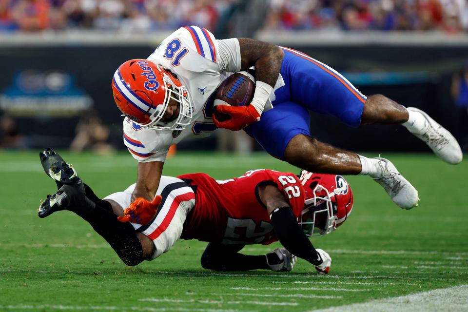 Georgia defensive back Javon Bullard tackles Florida tight end Dante Zanders during the second half at TIAA Bank Field.