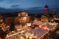 BERLIN, GERMANY - NOVEMBER 26: The annual Christmas market at Gendarmenmarkt stands illuminated in the city center on its opening day on November 26, 2012 in Berlin, Germany. Christmas markets, with their stalls selling mulled wine, Christmas tree decorations and other delights, are an integral part of German Christmas tradition, and many of them opened across Germany today. (Photo by Sean Gallup/Getty Images)