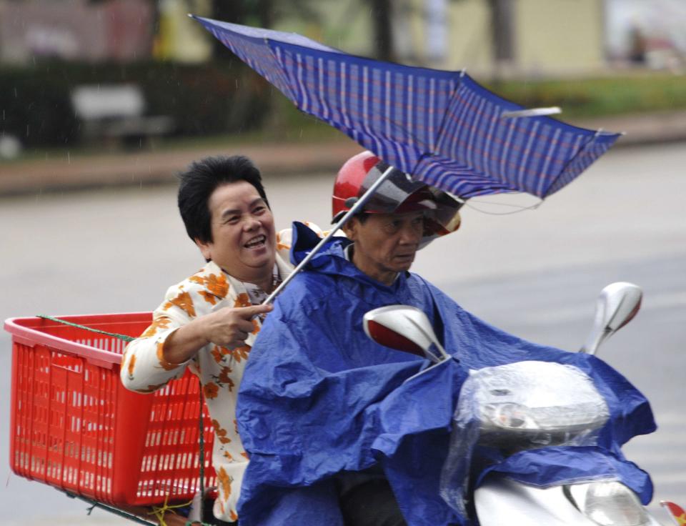 People ride against rain and wind under the influence of Typhoon Haiyan, in Qionghai, south China's Hainan province on November 10, 2013, as it approaches Vietnam. (REUTERS/Stringer)
