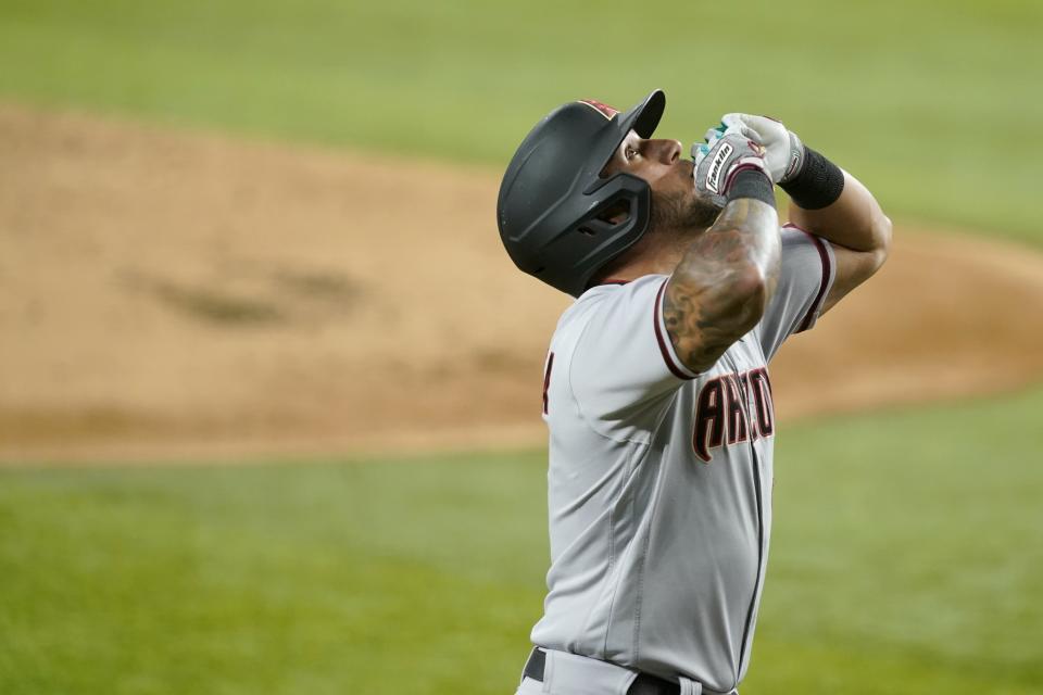 Arizona Diamondbacks' David Peralta celebrates his solo home run as he nears home during the second inning of the team's baseball game against the Texas Rangers in Arlington, Texas, Wednesday, July 28, 2021. (AP Photo/Tony Gutierrez)