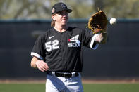 Chicago White Sox starting pitcher Mike Clevinger (52) works out during a spring training baseball practice, Wednesday, Feb. 15, 2023, in Phoenix. (AP Photo/Matt York)