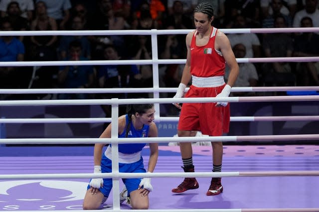 Algeria’s Imane Khelif, right, stands over Angela Carini 