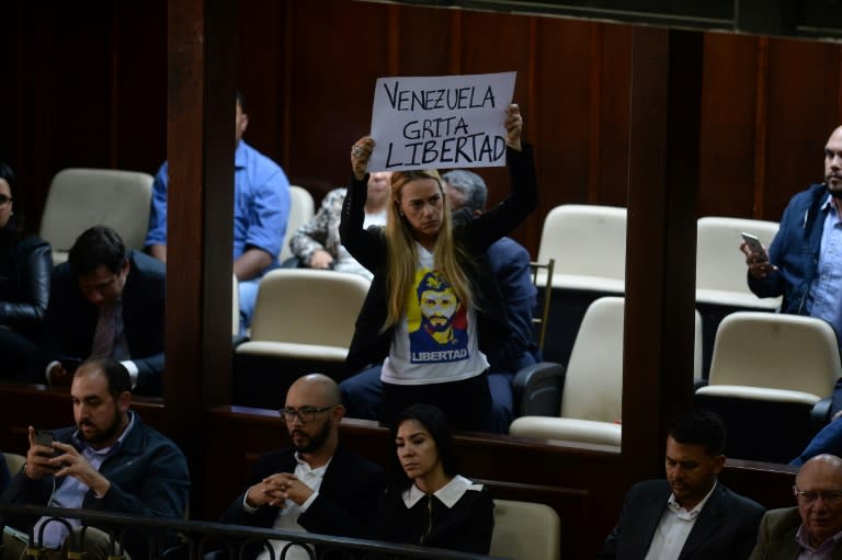 Activist Lilian Tintori displays a placard reading "Venezuela Screams for Freedom" as the opposition-led National Assembly holds a session