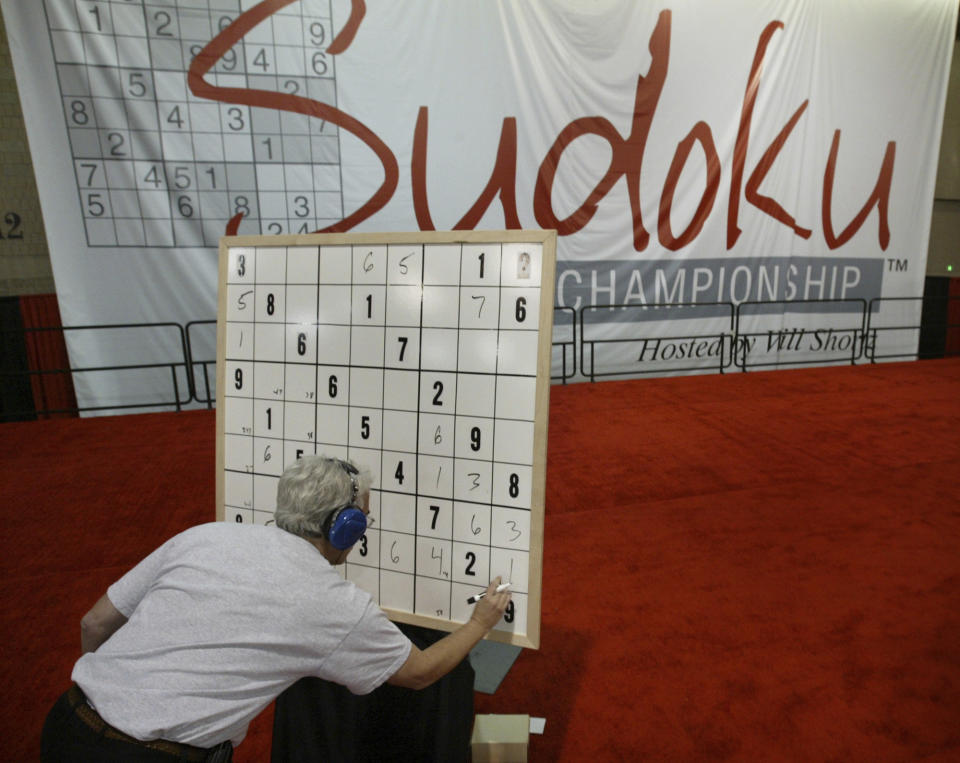 FILE - In this Oct. 20, 2007, file photo, Ronald Osher, of Stamford Conn., works on his puzzle in the final round during the Philadelphia Inquirer Sudoku National Championship in Philadelphia. Maki Kaji, known as the “Godfather of Sudoku,” the numbers puzzle he created that’s drawn fans around the world, has died, a spokesman for his Japanese company said Tuesday, Aug. 17, 2021. He was 69.(AP Photo/ Joseph Kaczmarek, File)