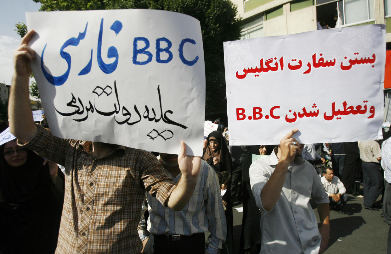 Supporters of President Mahmoud Ahmadinejad hold up placards against the British media during a rally in Tehran's Vali Asr Square on June 16, 2009. The rally, called by the Islamic Propagation Council, was staged at the same time as a rival gathering by supporters of defeated candidate Mir Hossein Mousavi. Farsi slogans read: "Closing the British Embassy and BBC," right, and "Persian BBC against the Iranian government."&nbsp; (Photo: ALIREZA SOTAKBAR/AFP/Getty Images)