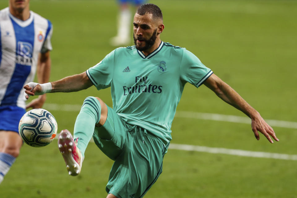 Real Madrid's Karim Benzema controls the ball during the Spanish La Liga soccer match between RCD Espanyol and Real Madrid at the Cornella-El Prat stadium in Barcelona, Spain, Sunday, June 28, 2020. (AP Photo/Joan Monfort)