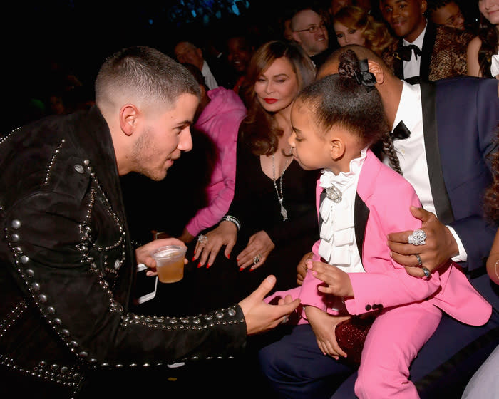 LOS ANGELES, CA - FEBRUARY 12:  Singer-songwriter Nick Jonas (L) and Blue Ivy Carter during The 59th GRAMMY Awards at STAPLES Center on February 12, 2017 in Los Angeles, California.  (Photo by Lester Cohen/Getty Images for NARAS)