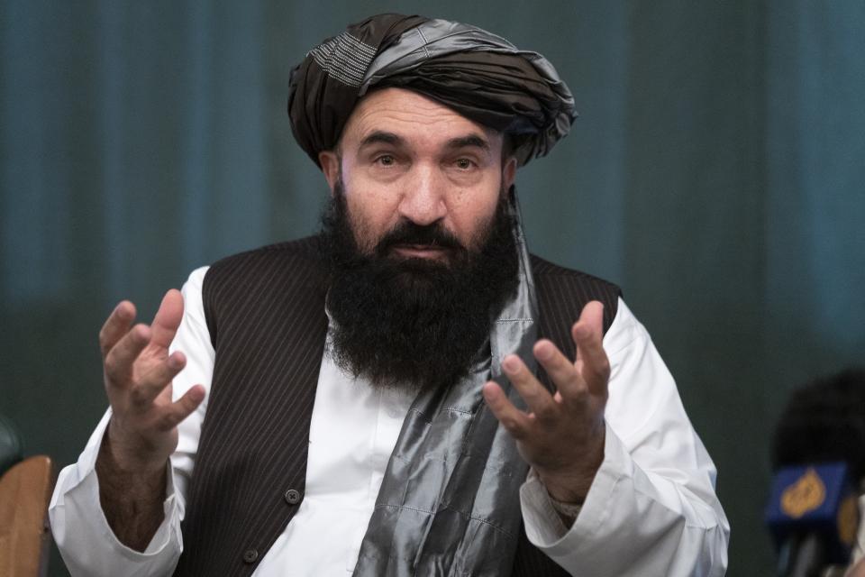 Khairullah Khairkhwa, former western Herat Governor and one of five Taliban released from the U.S. prison on Guantanamo Bay in exchange for U.S. soldier Bowe Bergdahl, gestures during a joint news conference in Moscow, Russia, Friday, March 19, 2021. The Taliban warned Washington against defying a May 1 deadline for the withdrawal of American and NATO troops from Afghanistan, and promising a "reaction," if the deadline is not met. (AP Photo/Alexander Zemlianichenko, Pool)