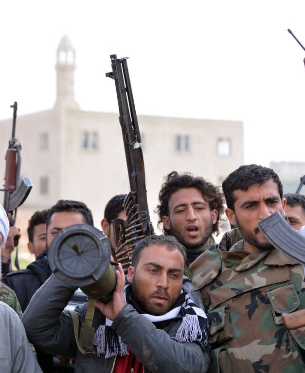 Rebel fighters prepare to fight against Syrian regime forces in the village of Kurnaz, close to the western city of Hama, on January 27, 2013. The United Nations says more than 60,000 people have been killed since the start of the conflict in March 2011