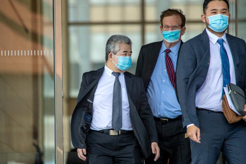 Los Angeles , CA - January 20: Raymond Chan, left, a former Los Angeles deputy mayor, and his attorney Harland Braun after a hearing for his upcoming trial on racketeering, fraud and bribery charges, exit Federal Court on Friday, Jan. 20, 2023 in Los Angeles , CA. (Irfan Khan / Los Angeles Times)