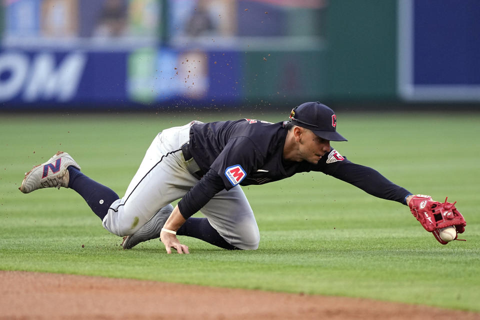 Cleveland Guardians second baseman Andres Gimenez reaches for a ball hit by Los Angeles Angels' Kevin Pillar during the first inning of a baseball game Friday, May 24, 2024, in Anaheim, Calif. Pillar was safe at first on the play. (AP Photo/Mark J. Terrill)