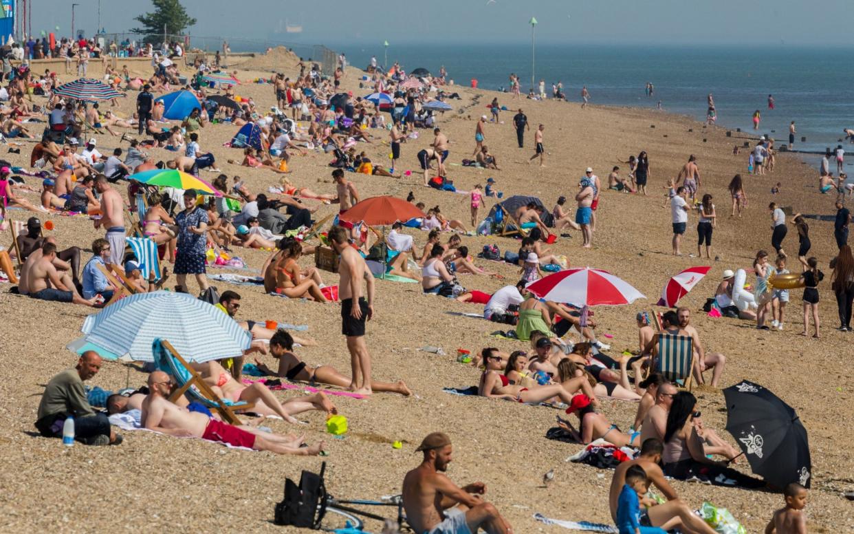 Crowds of people visiting Southend beach during hot and sunny weather in Southend, Essex, Britain, 21 May, 2020. As the UK starts easing its lockdown restrictions, many workers across the country are facing the dilemma of whether returning to their workplaces is safe for them or not. Meanwhile, the UK's economy has suffered a 2-percent fall, its worst decline since the 2008 financial crash, due to the global effects of the ongoing pandemic of the COVID-19 disease caused by the SARS-CoV-2 coronavirus. Coronavirus in Britain, Southend - Shutterstock