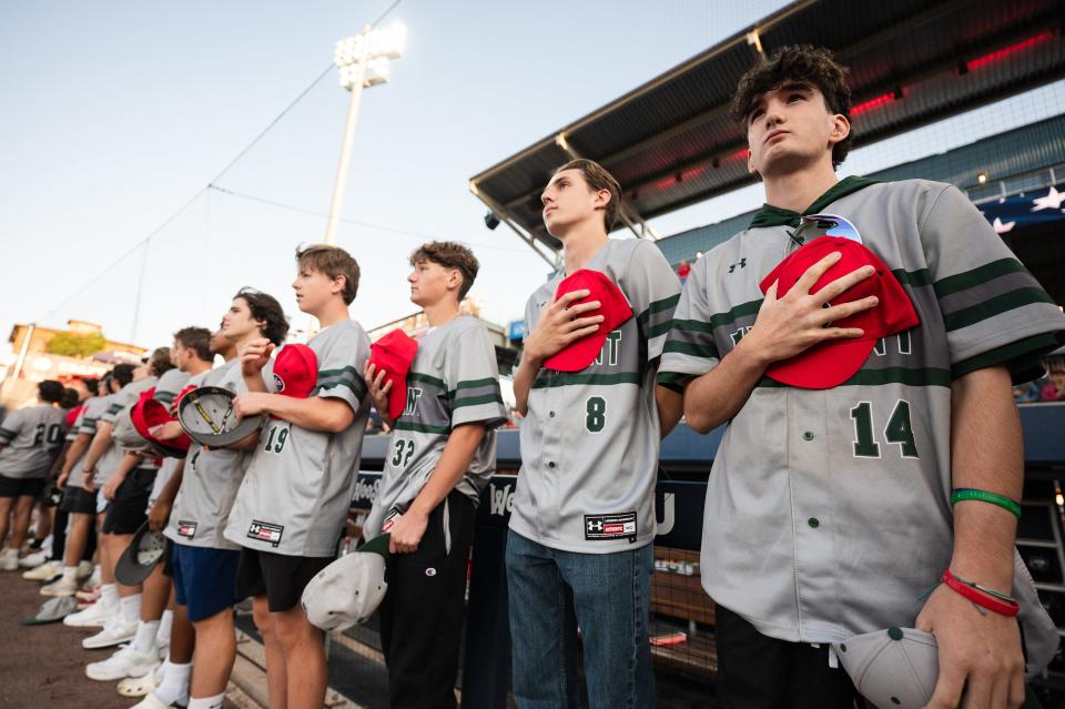 Divison 3 state champion Oakmont Regional High School players get ready for the national anthem before Thursday night's WooSox game at Polar Park.