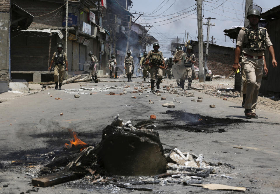 Indian paramilitary soldiers patrol during clashes with Kashmiri Muslim protesters