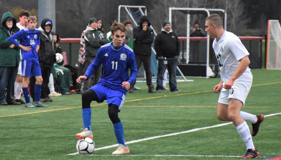 Poland Tornado Daetyn Jones (left) makes a run against Hamilton during Section III's Oct. 30 Class D title match. Jones, a senior, scored the tying goal Saturday that helped the Tornadoes share the state championship with Chazy.