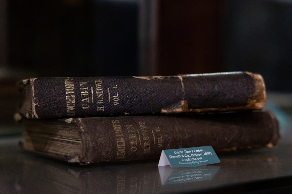 A bookcase in the Harriet Beecher Stowe House in Walnut Hills displays a first-edition two-volume copy of the best known of Stowe's 30 books, "Uncle Tom's Cabin."