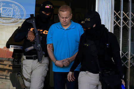 Agents of the Technical Criminal Investigation Agency (ATIC) escort Kentucky attorney Eric Christopher Conn, 57, wanted by the FBI over his role in a disability fraud scheme, in Tegucigalpa, Honduras December 5, 2017. REUTERS/Jorge Cabrera