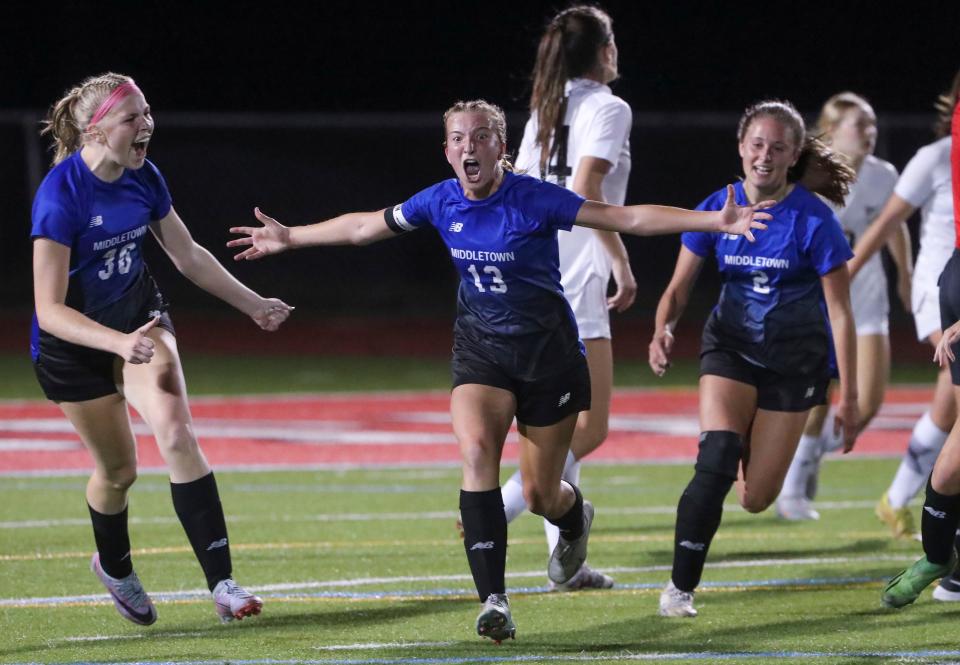 Middletown's Gabby Riley (center) reacts with teammates Sara Conkling (left) and Lily Holcroft after Riley scored the first of her three goal in the Cavs' 4-2 win against Appoquinimink in the DIAA Division I championship game at Delaware State University's Alumni Stadium, Friday, June 2, 2023.