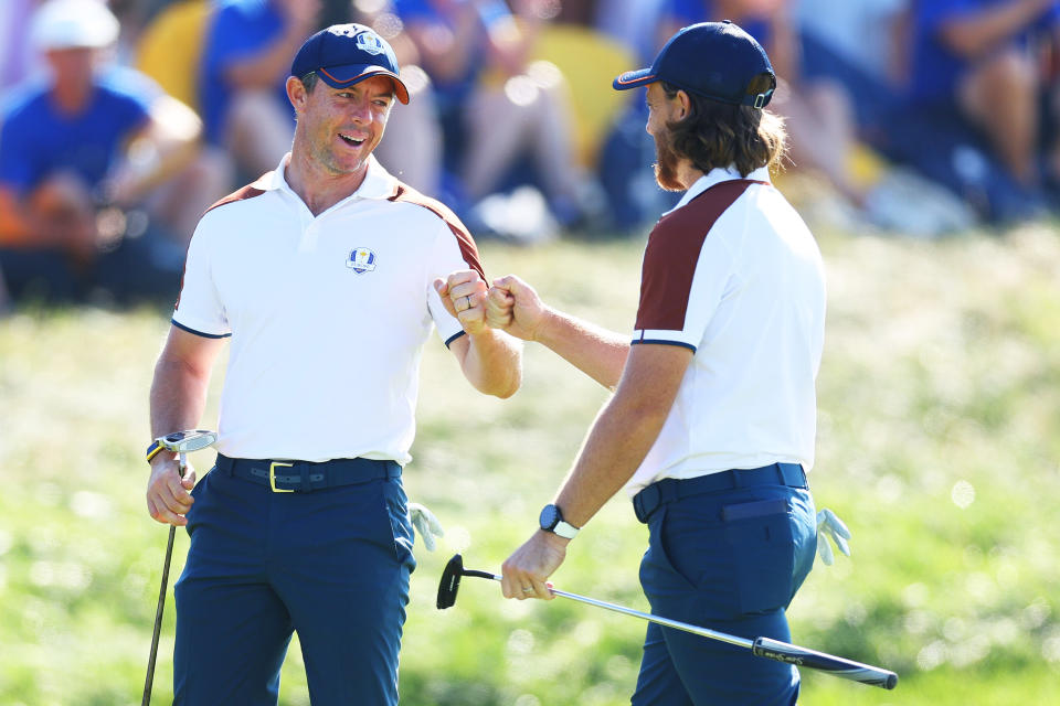 Rory McIlroy fist bumps teammate Tommy Fleetwood of Team Europe on the 12th green during the Saturday morning foursomes matches of the 2023 Ryder Cup at Marco Simone Golf Club on September 30, 2023 in Rome, Italy. (Photo by Andrew Redington/Getty Images)