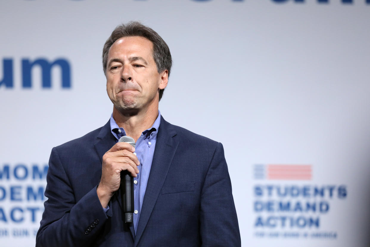 Montana Gov. Steve Bullock holds a microphone