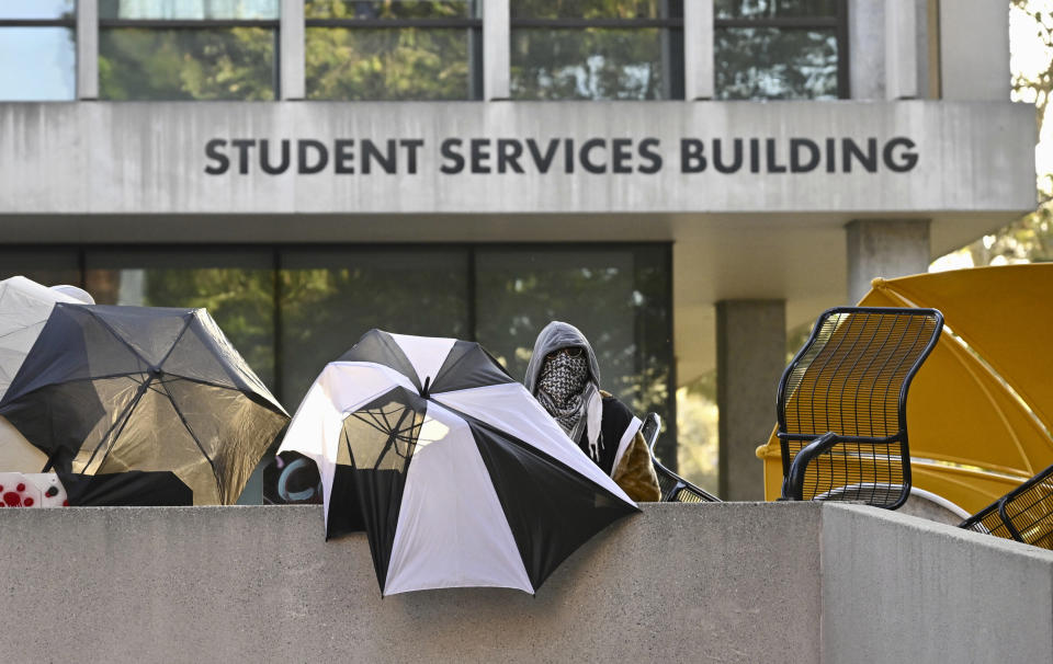 FILE - Pro-Palestinian student protesters barricade the entrance to the student services building of California State University, Los Angeles administration on the campus in Los Angeles on Wednesday, June 12, 2024. Police on Monday, June 17, 2024, cleared an entrenched pro-Palestinian encampment at California State University, Los Angeles, just days after demonstrators occupied and trashed a building. (Keith Birmingham/The Orange County Register via AP, File)