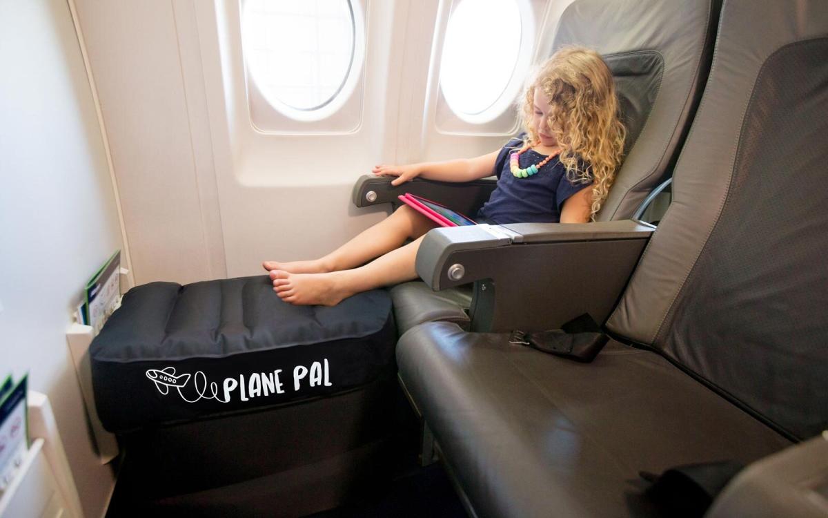 A Female Passenger Traveling by Plane Sleeping on Cushion Airplane