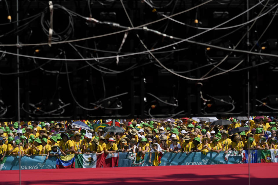 Thousands of Workd Youth Day volunteers wait to meet Pope Francis at Passeio Marítimo in Algés, just outside Lisbon, Sunday, Aug. 6, 2023. Francis told young people on Sunday the Catholic Church needs them and urged them to follow their dreams as he wrapped up World Youth Day in Portugal with a massive open-air Mass and an announcement that the next edition would be held in Asia for the first time in three decades. (AP Photo/Gregorio Borgia)