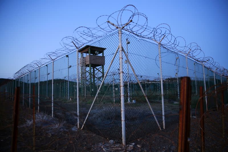 FILE PHOTO: Chain link fence and concertina wire surrounds a deserted guard tower within Joint Task Force Guantanamo's Camp Delta