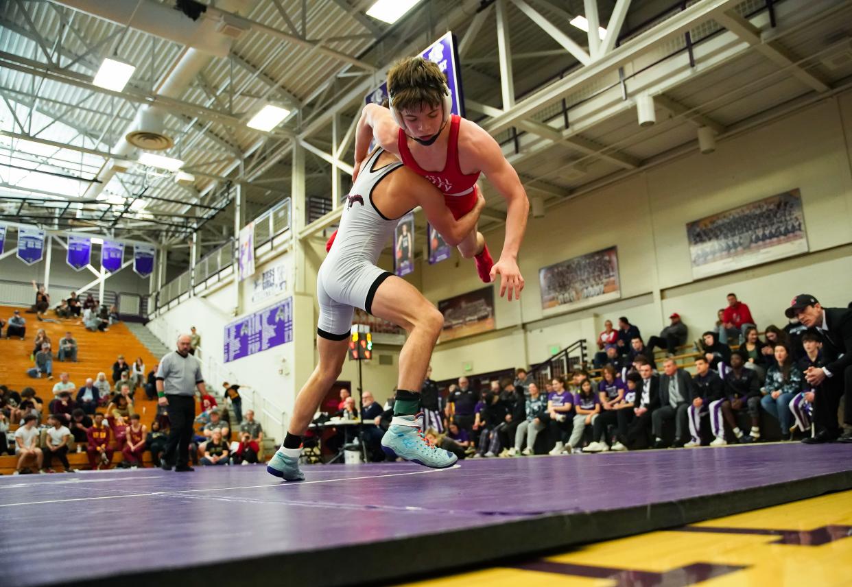 Edgewood’s John Orman (left) wrestles against Tell City’s Walter Hagedorn in the 120-pound final during the IHSAA wrestling regional at Bloomington South on Saturday, Feb. 3, 2024.