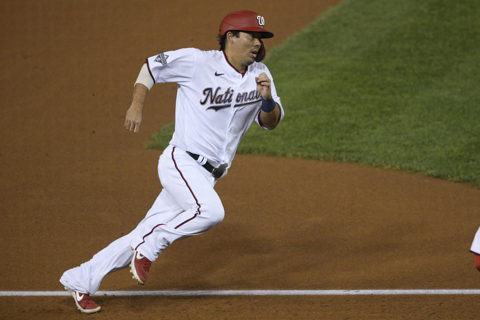 Washington Nationals' Kurt Suzuki runs toward home to score on a single by Josh Harrison during the fourth inning of the team's baseball game against the New York Mets, Thursday, Sept. 24, 2020, in Washington. (AP Photo/Nick Wass)