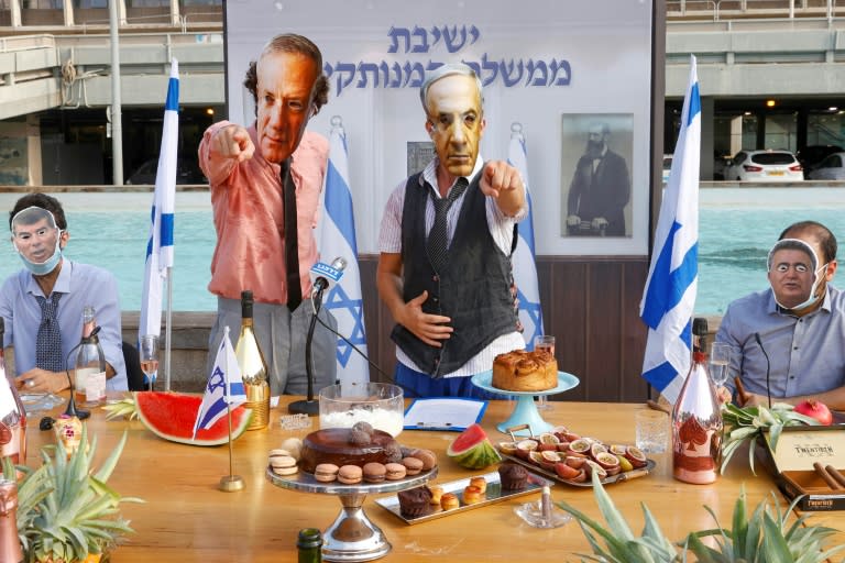 Israeli comedians, wearing masks bearing the portraits of leaders including Prime Minister Benjamin Netanyahu, stage a fake cabinet meeting protesting the government's handling of the Covid-19 pandemic