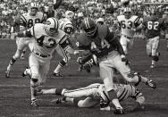 FILE - In this Sept.1969 file photo, Denver Broncos' Floyd Little avoids the tackle of New York Jets' Steve O'Neal (20) during a football game in Denver. Little, the Hall of Fame running back who starred at Syracuse and for the Denver Broncos, has died. The Pro Football Hall of Fame said he died Friday, Jan. 1, 2021. (AP Photo/File)