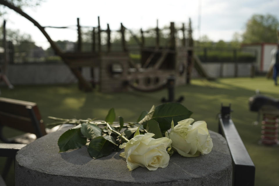 Roses lay at the playground after a knife attack Thursday, June 8, 2023 in Annecy, French Alps. A a man with a knife stabbed four young children at a lakeside park in the French Alps on Thursday, assaulting at least one in a stroller repeatedly. The children between 22 months and 3 years old suffered life-threatening injuries, and two adults also were wounded, authorities said. (AP Photo/Laurent Cipriani)