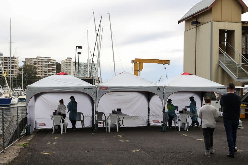 Medical workers and members of the public are seen at a COVID-19 pop-up testing centre in Sydney