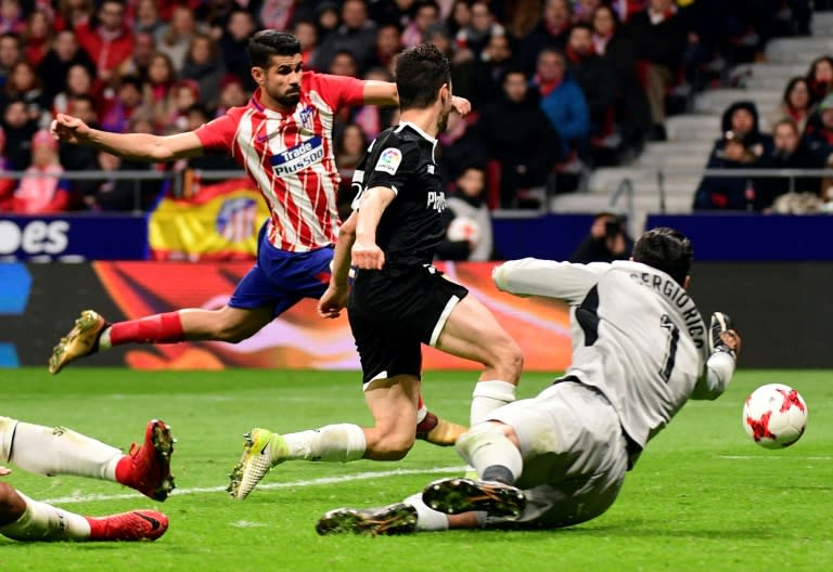 Atletico Madrid's forward Diego Costa (L) shoots against Sevilla's goalkeeper Sergio Rico Gonzalez on January 17, 2018