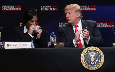 U.S. President Donald Trump looks on as Evelyn Rodriguez, whose daughter Kayla Cuevas was killed by MS-13 gang members, cries as she speaks during a roundtable on immigration and the gang MS-13 at the Morrelly Homeland Security Center in Bethpage, New York, U.S., May 23, 2018. REUTERS/Kevin Lamarque