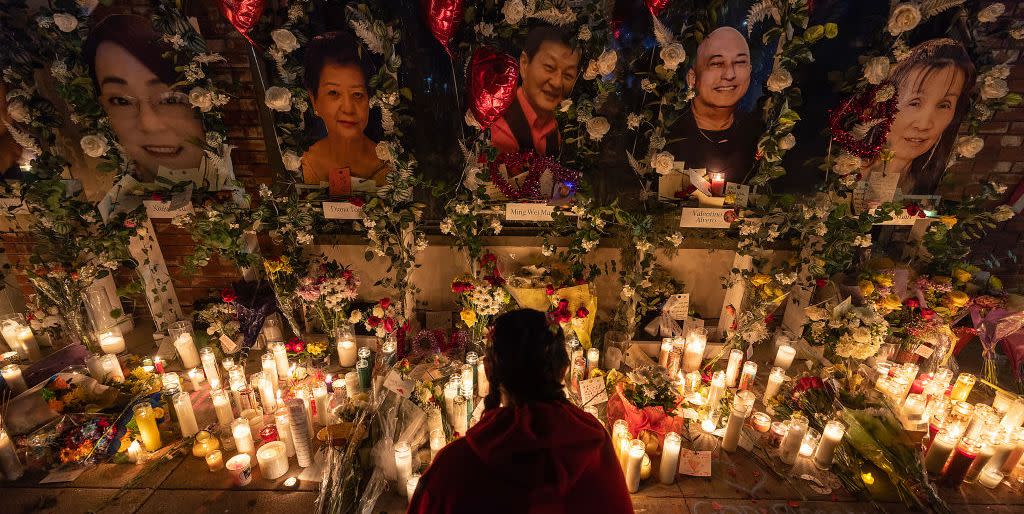 a young woman lights incense at a vigil for those murdered during a mass shooting at star ballroom dance studio in monterey park, california