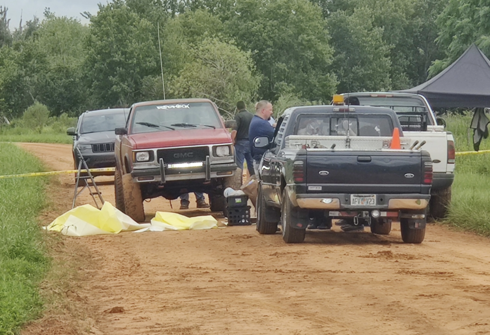 Pictured are police and the victim's trucks at the scene near the lake. Source: News Channel 8