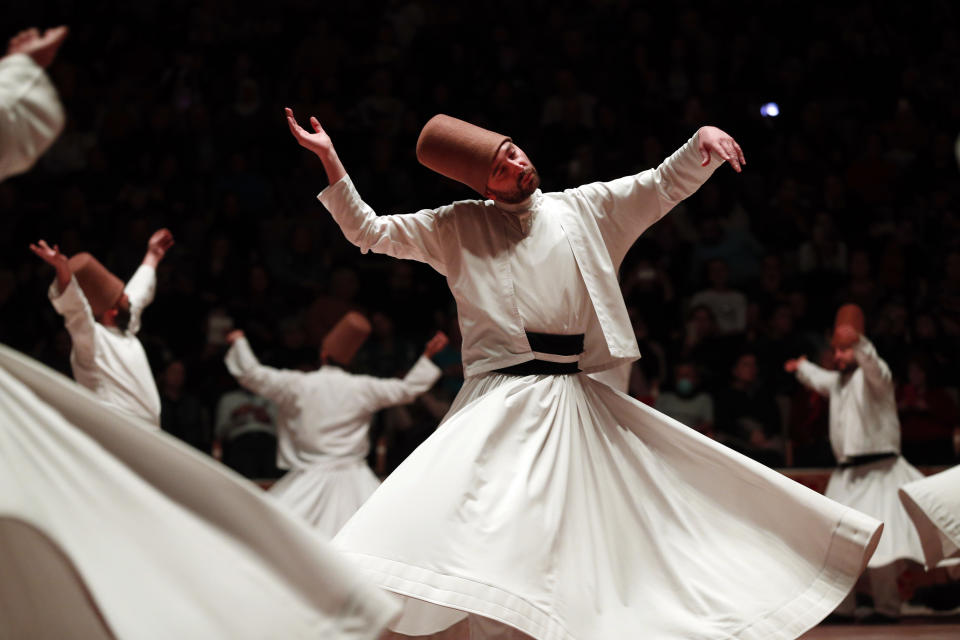 In this photo taken on Sunday, Dec. 16, 2018, whirling dervishes of the Mevlevi order perform during a Sheb-i Arus ceremony in Konya, central Turkey. Every December the Anatolian city hosts a series of events to commemorate the death of 13th century Islamic scholar, poet and Sufi mystic Jalaladdin Rumi. (AP Photo/Lefteris Pitarakis)