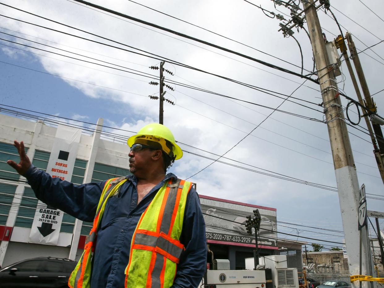 An employee of the Puerto Rico Electric Power Authority during repair work on power lines affected by Hurricane Maria in San Juan, Puerto Rico: Photo by Jose Jimenez Tirado/Getty Images