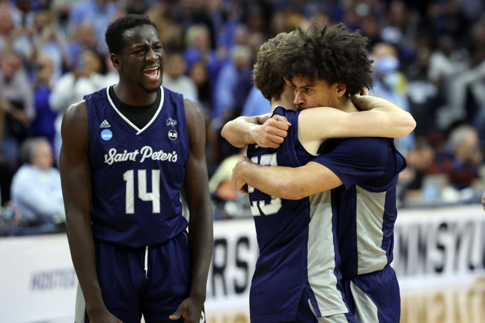 Peacocks guard Matthew Lee, right, guard Doug Edert (25) and forward Hassan Drame (14) celebrate after eliminating the Boilermakers.