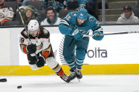 Anaheim Ducks right wing Troy Terry (19) falls toward the puck next to San Jose Sharks defenseman Mario Ferraro (38) during the second period of an NHL hockey game in San Jose, Calif., Tuesday, Nov. 1, 2022. (AP Photo/Jeff Chiu)