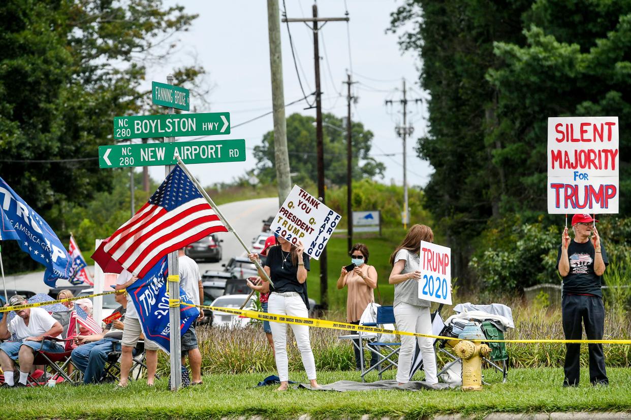 People gathered along Donald Trump's motorcade route August 24, 2020, in Henderson County, a Republican stronghold in the state's west.