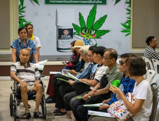 Patients wait to register for treatment at the opening of a medical marijuana clinic in Bangkok