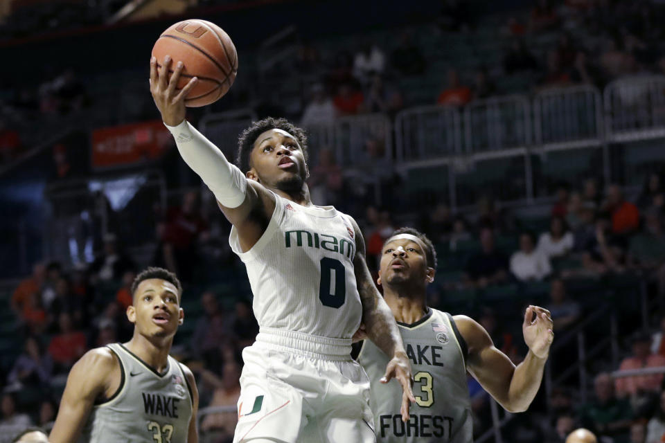 FILE - Miami guard Chris Lykes (0) goes up for a shot against Wake Forest forward Ody Oguama (33) and guard Andrien White (13) during the first half of an NCAA college basketball game in Coral Gables, Fla., in this Saturday, Feb. 15, 2020, file photo. Dynamic Miami Hurricanes point guard Chris Lykes is back at practice and may be back in action for the first time in two months Saturday, Feb. 6, 2021, against No. 16 Virginia Tech. (AP Photo/Wilfredo Lee)