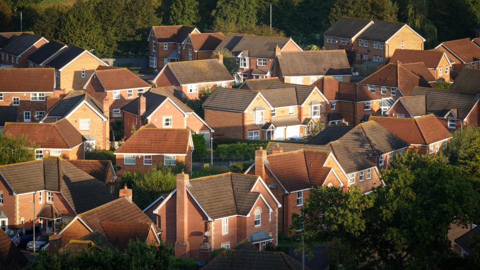 GLASTONBURY, UNITED KINGDOM - MAY 15: The sun shines on roofs of homes in a suburbian housing estate, on May 15, 2022 in Glastonbury, England. The UK is currently facing a cost of living crisis, as inflation hits a near-30-year high, the war in Ukraine puts pressure on food prices and rising energy bills squeeze household incomes still further. To add to the misery, many UK households face a further rises in home energy prices as energy price caps are raised.  (Photo by Matt Cardy/Getty Images)