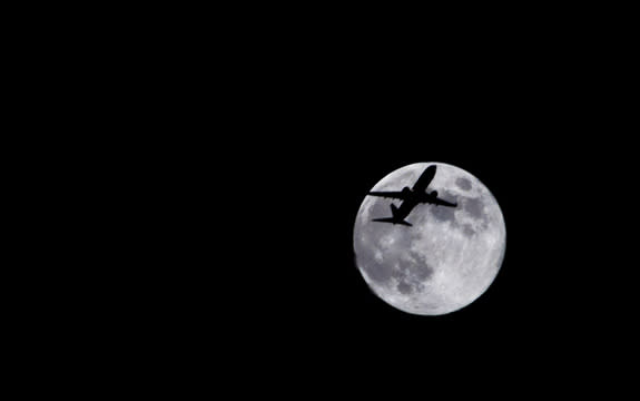 Photographer Sid Vedula captured this amazing view of the full moon of Aug. 1, 2012, from Houston, TX, with a passing airplane in silhouette.